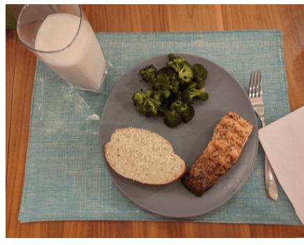 Client X's food-journal photo of a plate with fish, rice and broccoli