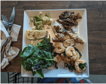 Client X's food-journal photo showing a varied meal with vegetables